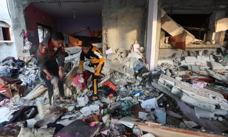 Palestinian boys inspect inside a house damaged in an Israeli strike in Rafah, southern Gaza