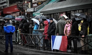 Parisians wait for the hearse transporting the coffin containing the body of Arnaud Beltrame.