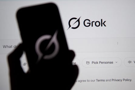 A man holding a phone showing the GROC logo