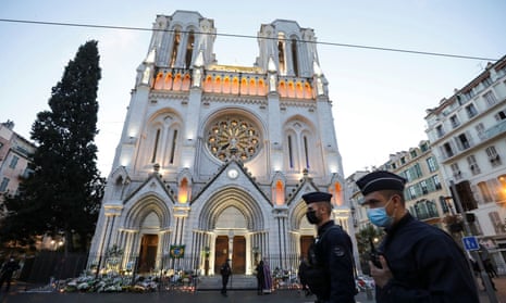 Police officers walk in front of the Notre Dame church before a mass to pay tribute to the victims of the knife attack in Nice.