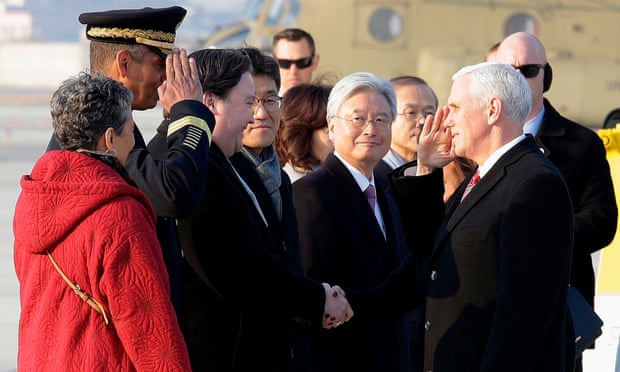 Mike Pence salutes US General Vincent Brooks (2nd L), commander of the United Nations Command, US Forces Korea and Combined Forces Command, upon his arrival at Osan Air Base in Pyeongtaek.