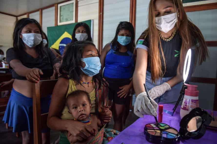 An indigenous Yanomami woman has her makeup done at the 5th Special Frontier Platoon in Auari, Roraima state, Brazil, on 30 June 2020.