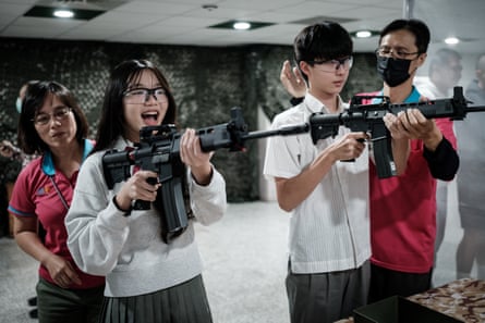Students learn how to use an airsoft gun from Taiwanese military instructors at Kaohsiung Municipal Sanmin senior high school in Kaohsiung as part of national defence education program.