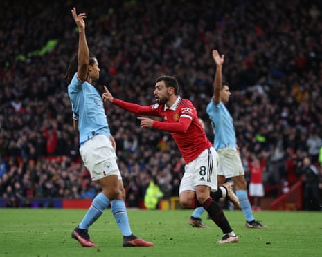 Bruno Fernandes celebrates scoring, gesturing as Manchester City defenders raise their arms