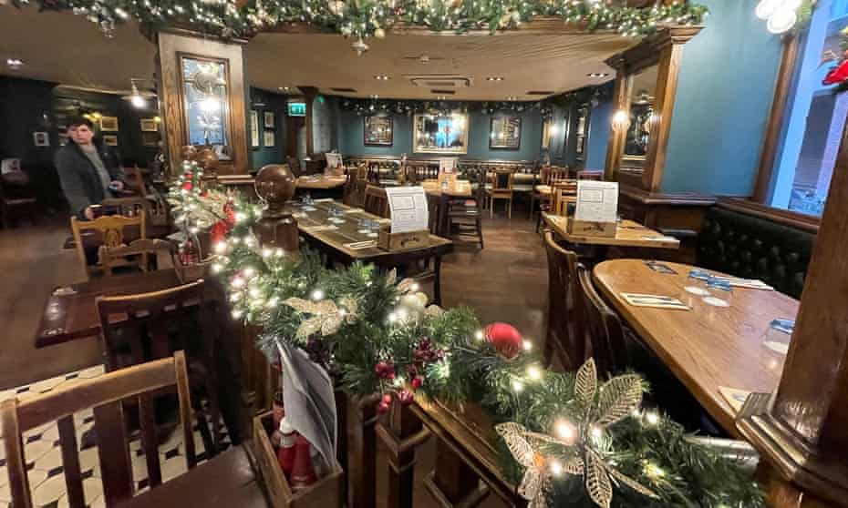 Empty tables are seen in a bar-restaurant in London on 18th December, as seated diner numbers tumble