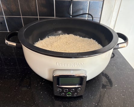 A white and black GreenPan Omni Cooker on a black kitchen worktop