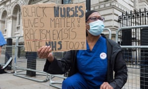 A group of nurses wearing face masks protest outside Downing Street on June 3 demanding a pay rise, effective protection against COVID-19 and highlighting a disproportionately higher mortality rate from the novel coronavirus among BAME ethnic minority groups.
