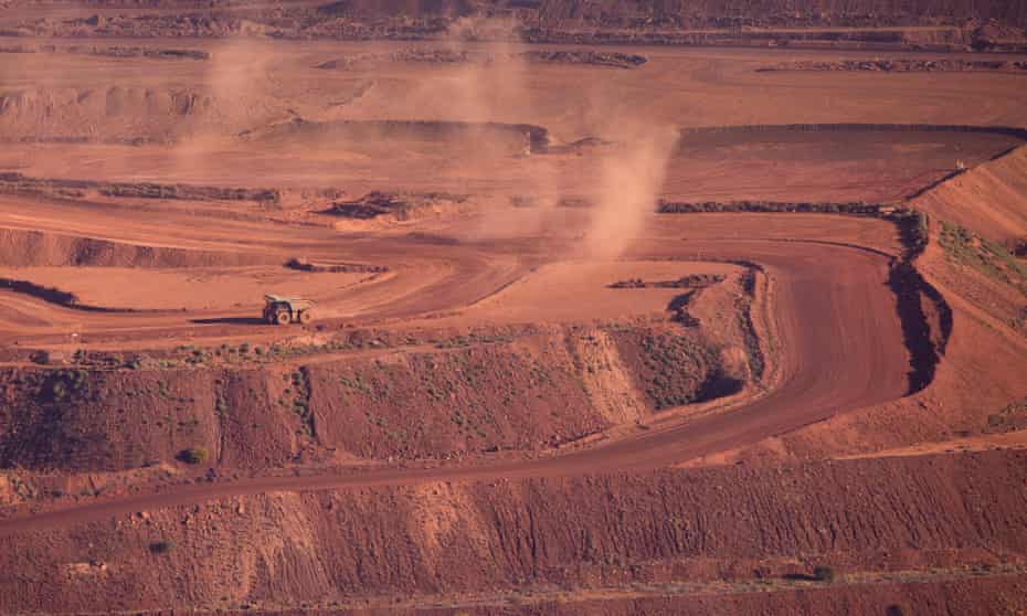 An iron ore truck drives through the Rio Tinto Marandoo mine site in Western Australia