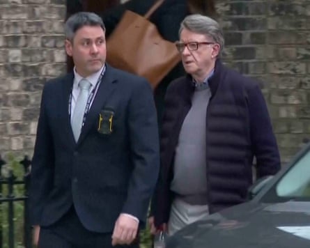 Peter Mandelson being escorted to a car