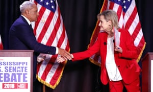 Democrat Mike Espy and Republican Cindy Hyde-Smith shake hands at a debate in Jackson, Mississippi on 20 November. 