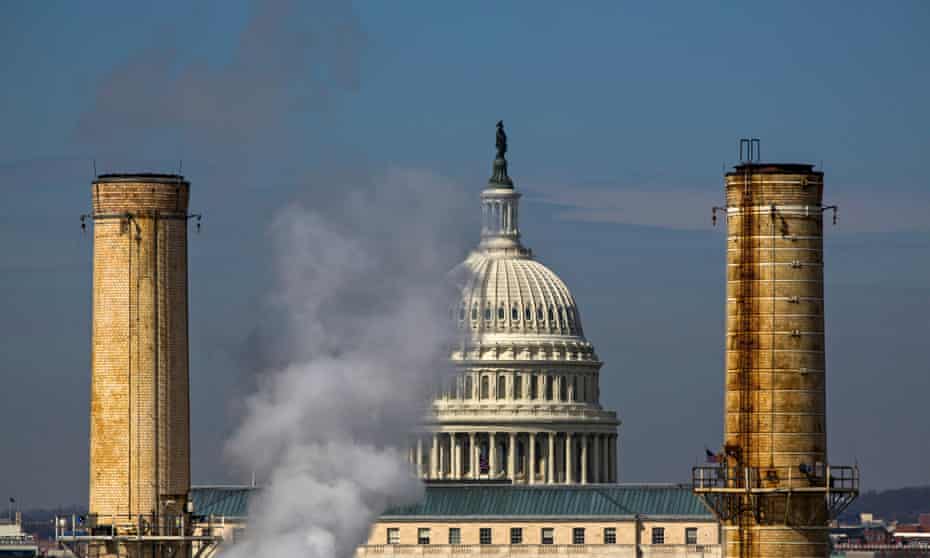 The dome of the US Capitol is seen behind the smokestacks of the Capitol Power Plant, a coal-burning plant in Washington DC.