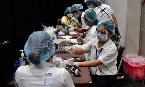 Health workers prepare to administer Covid jabs at a vaccination site in the Siam Paragon shopping mall in Bangkok