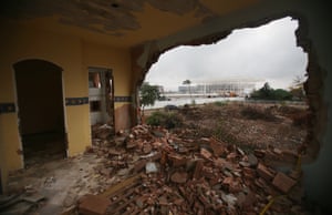 A partially demolished home in the Vila Autódromo favela, with the Olympic Aquatics Stadium under construction in the background.