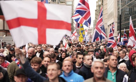 Tommy Robinson supporters with union flags and St George’s flags march in London