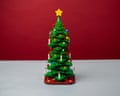 A fully assembled lego christmas tree against a red background