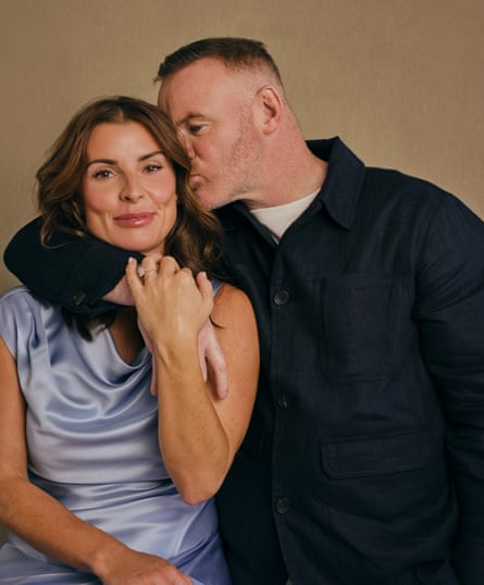 Wayne and Coleen Rooney - he has his arm around her and is giving her a kiss on the side of her head while she smiles