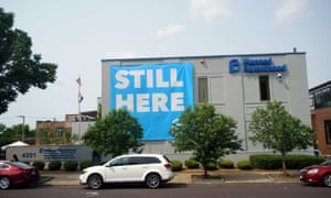 A banner stating ‘STILL HERE’ hangs on the side of the Planned Parenthood building after a judge granted a temporary restraining order on the closing of Missouri’s sole remaining clinic in St Louis.