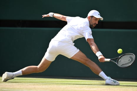 Novak Djokovic returns to Italy's Jannik Sinner during their men's singles semi-final