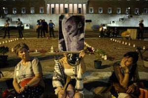 A woman at a pro-Palestinian rally holds aloft an image of a starving child