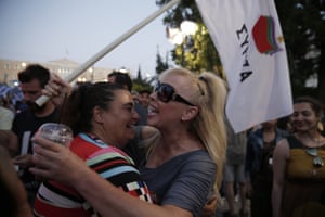 Supporters of the No vote react after the first results of the referendum at Syntagma square in Athens, Sunday, July 5, 2015. Greece faced an uncharted future as its interior ministry predicted Sunday that more than 60 percent of voters in a hastily called referendum had rejected creditors’ demands for more austerity in exchange for rescue loans. (AP Photo/Petros Giannakouris)