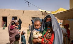 Afghan women wait to see a doctor at a mobile clinic for women and children in Helmand province