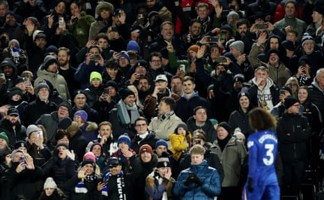 Chelsea's Marc Cucurella leaves the pitch after he is sent off as the Fulham fans cheer.