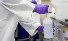 A researcher pours a PFAS water sample into a container