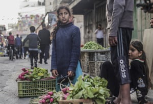 Gaza City, Gaza: Palestinian children sell vegetables in the Zawia market