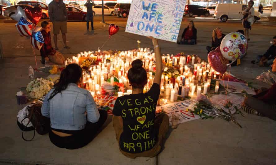 Mourners pay tribute at a makeshift memorial on the Las Vegas Strip