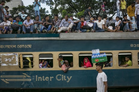 Bangladeshis aboard a packed train travel home to their villages from Dhaka