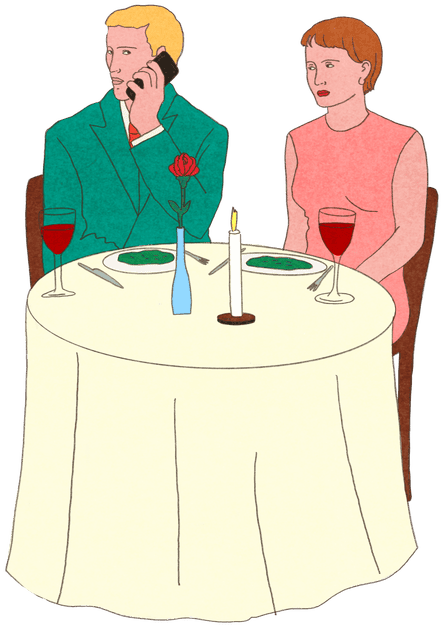 A woman sits for dinner with a man who is turned away and on his phone