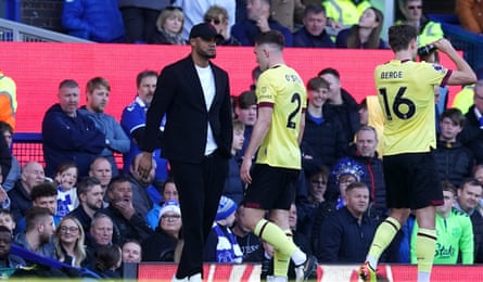 Dara O’Shea walks past his manager, Vincent Kompany, after being shown a straight red card.