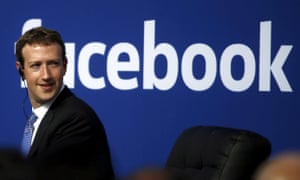 mark zuckerberg in front of a facebook logo