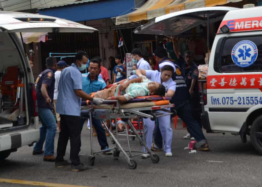 Injured people receive first aid after a bomb exploded in Trang