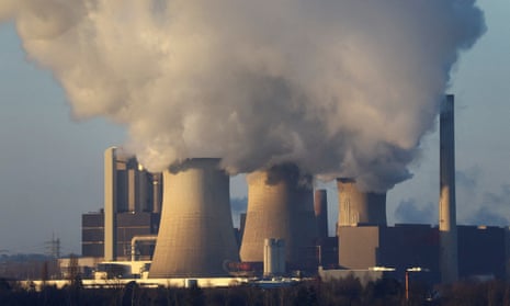 Smoke rises from cooling towers