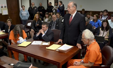 Deborah Leonard and Bruce Leonard sit next to their attorneys in court.