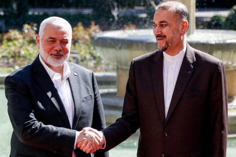 Iran's foreign minister Hossein Amir-Abdollahian (R) receives Hamas' Doha-based political bureau chief Ismail Haniyeh at the foreign ministry headquarters in Tehran on 26 March.