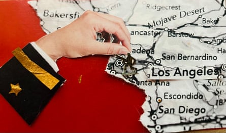 A graphic illustration of a black-and-white map of the US alongside a red ocean, with a white hand coming out of a military jacket cuff curled around Los Angeles.