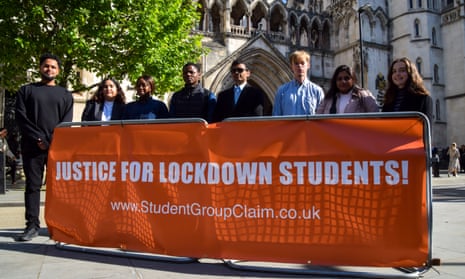 Students stand outside the Royal Courts of Justice.  Nearly 1,000 students are attempting a group action against UCL.