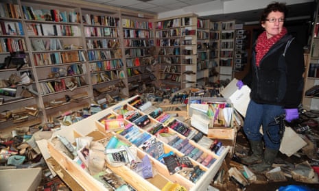 Catherine Hetherington, proprietor of the New Bookshop in Cockermouth, studies the damage done by floodwater.