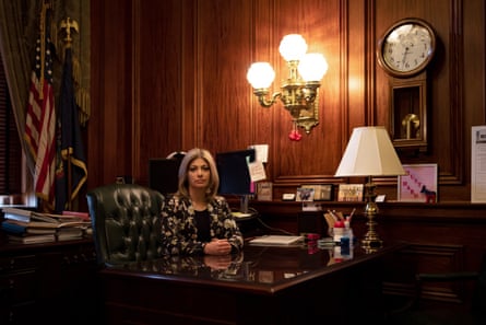a woman sitting at a desk in office