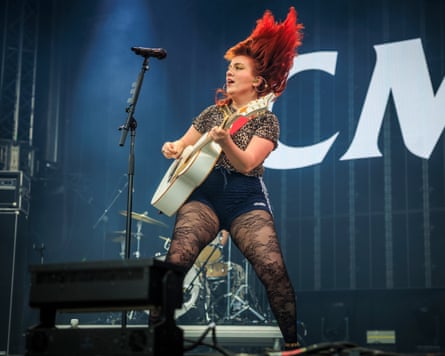 CMAT plays guitar