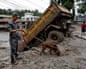 A security force member and his sniffer dog search for survivors, following devastating floods, in Trishuli in Nuwakot district, Nepal, August 27, 2026.