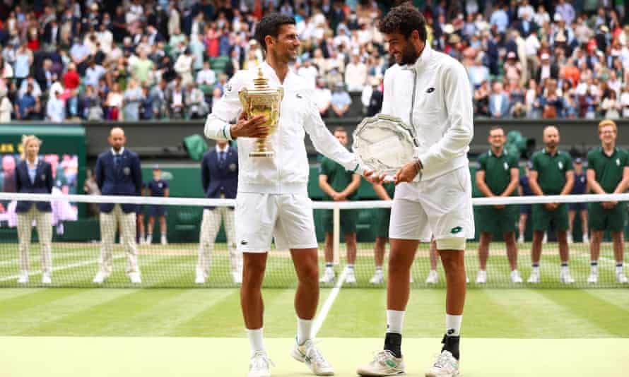Matteo Berrettini holds his Wimbledon runner-up trophy next to the winner, Novak Djokovic, after last year’s final.