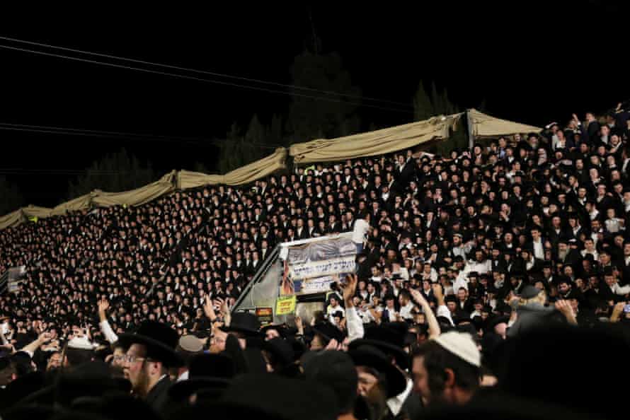 Jewish worshippers sing and dance on temporary seating at the Lag Baomer event in Mount Meron, northern Israel.
