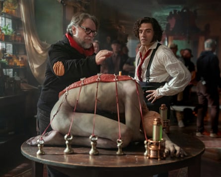 Del Toro and Isaac look at ‘the creature’ on a table