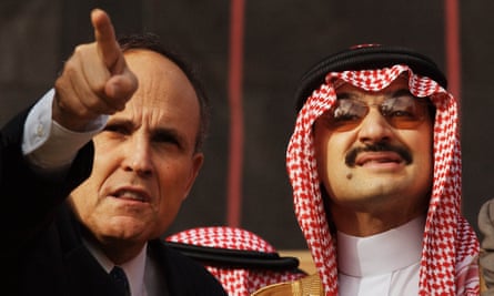 One month after the terrorist attacks on the World Trade Center, Alwaleed is escorted by then mayor Rudi Giuliani at the site of the former towers.