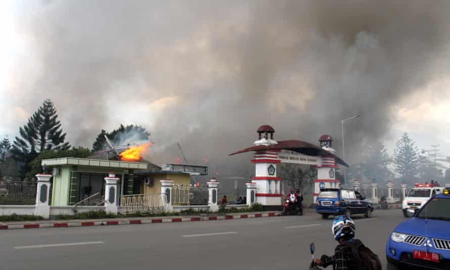 Smoke rise from a burning building after a violent rally in Wamena, Papua Province.