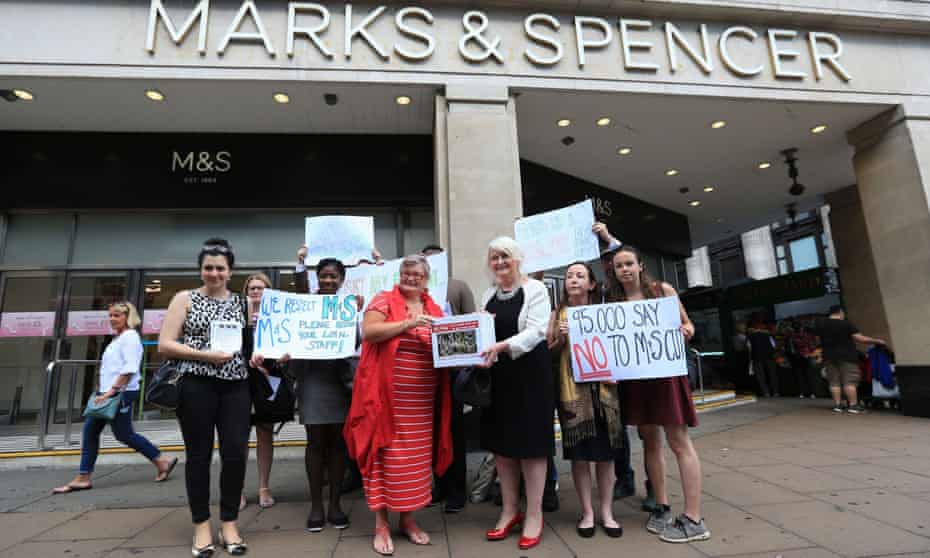Protesters gather outside Marks and Spencer’s flagship store in Oxford Street, central London, to deliver a petition urging the retailer to scrap proposed pay cuts to offset the cost of the national living wage.