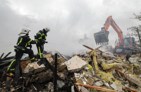 Ukrainian rescuers work at the site of a residential area struck by a rocket in an overnight Russian strike on a village near Kyiv. The picture was taken on 25 May 2025.